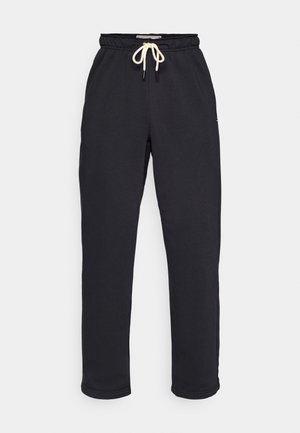 Pantalones de chándal gris oscuro de mezcla de algodón, con una cinturilla elástica y cordones beige, y puños ajustados en los tobillos.