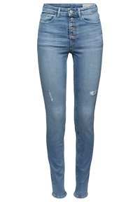 Jeans skinny azul claro con cintura alta, cinco botones, desgastes sutiles y textura clásica de denim. Sin adornos ni patrones.