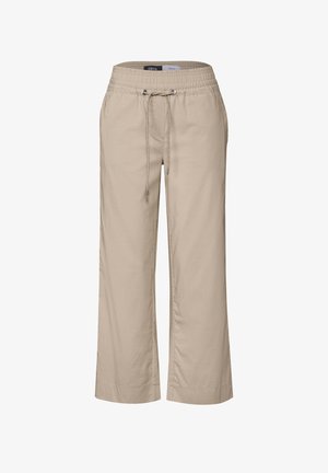 Beżowe, luźne spodnie z elastycznym paskiem w talii i regulowanym sznurkiem. Wykonane z lekkiego materiału, z prostym krojem i bocznymi kieszeniami.