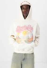 Cream hoodie with a colorful graphic design depicting a sun and floral elements. Features a drawstring hood and relaxed fit.