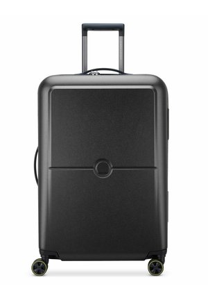 Black hard-shell suitcase with a smooth texture, retractable handle, and four wheels. Round logo detail centered on the front panel.
