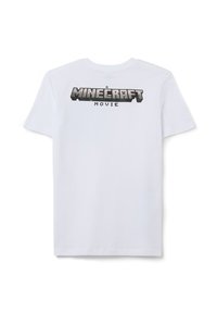 Witte katoenen t-shirt met een grafische print die "A MINECRAFT MOVIE" in grote zwart en grijs pixelachtige letters weergeeft. Korte mouwen.