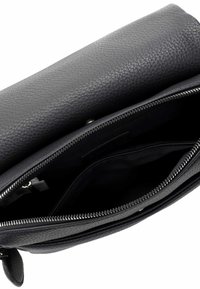 Black leather handbag featuring a textured exterior, zippered closure, and multiple interior compartments. Smooth lining inside.