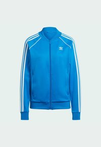 Sweatshirt azul com fecho éclair, feito de tecido leve. Apresenta riscas brancas nas mangas, punhos em canelado e um pequeno logótipo no peito.