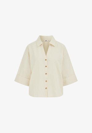 Chemise beige à manches courtes, boutonnée, avec de fines rayures verticales, large col et boutons marron sur le devant.