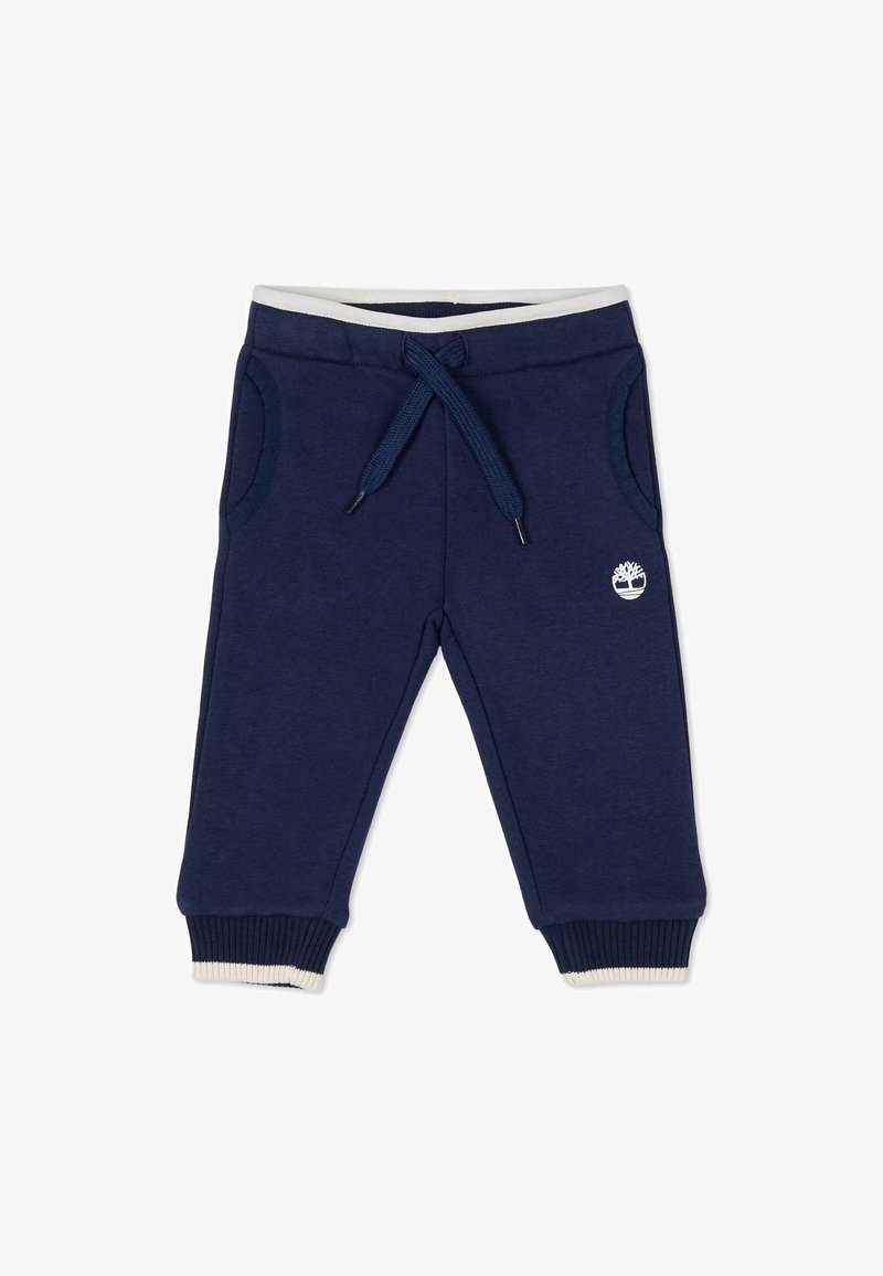 Granatowe dresy z elastycznym paskiem, bocznymi kieszeniami, ściągaczami na mankietach i małym białym logo na lewej nodze. Wykonane z miękkiego materiału mieszanki bawełny.