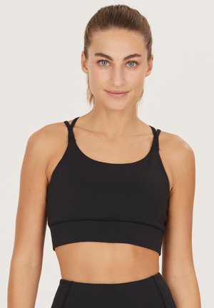 Athlecia SPORT - Reggiseno sportivo con sostegno medio - black