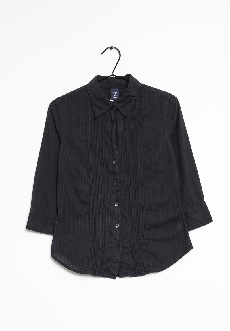 Chemise noire à manches longues avec de fines rayures verticales, col et détails plissés à l'avant, suspendue sur un cintre noir.