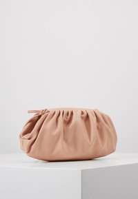 Peach-colored synthetic leather clutch bag with gathered texture, rounded shape, and a tied accent on top. Smooth surface finish.