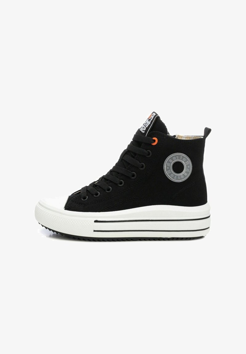 Zapatilla alta negra con suela de goma blanca plana, ojales negros, acento naranja y detalle del logo circular en el lateral.