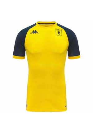 Maglia sportiva gialla con maniche blu scuro, con stemma nero di leone sul petto e logo nero a doppia silhouette sulla spalla.