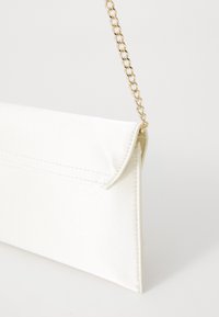 White satin clutch bag with a fold-over flap, finished with a gold chain strap. Simple design, smooth texture, minimal stitching details.