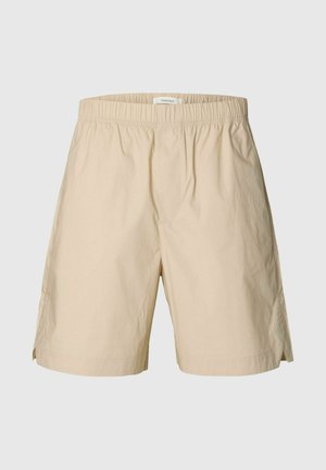 Beige shorts til knærne med elastisk midje og sidesliss, laget av lett stoff, forfra.