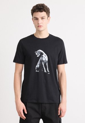 Black cotton t-shirt featuring a graphic of a dog in white. Short sleeves and crew neck. Simple, minimalist design with no visible accents.