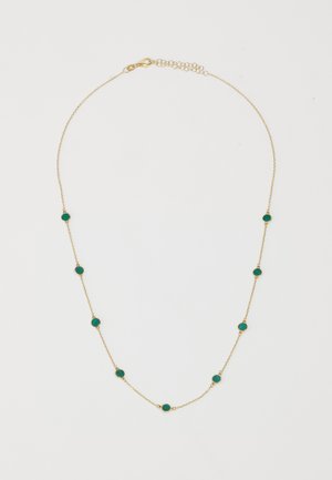 Kuldne kett, millel on ühtlaselt jaotatud türkiissinised ümmargused kivid. Iga kivi on paigutatud kullast äärde. Kaasas on homaariklamber ja pikendaja.