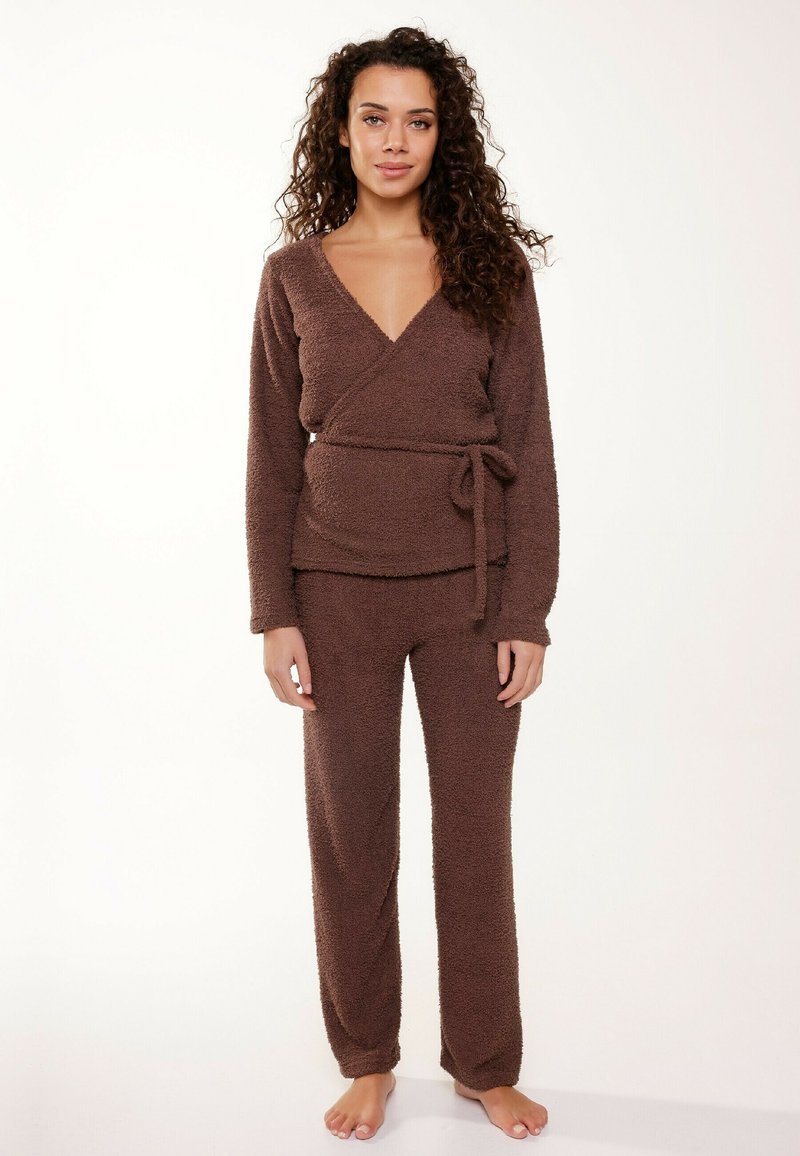 Brown, fluffy loungewear set featuring a wrap-top with long sleeves and a tied waist, paired with loose-fitting, textured pants.