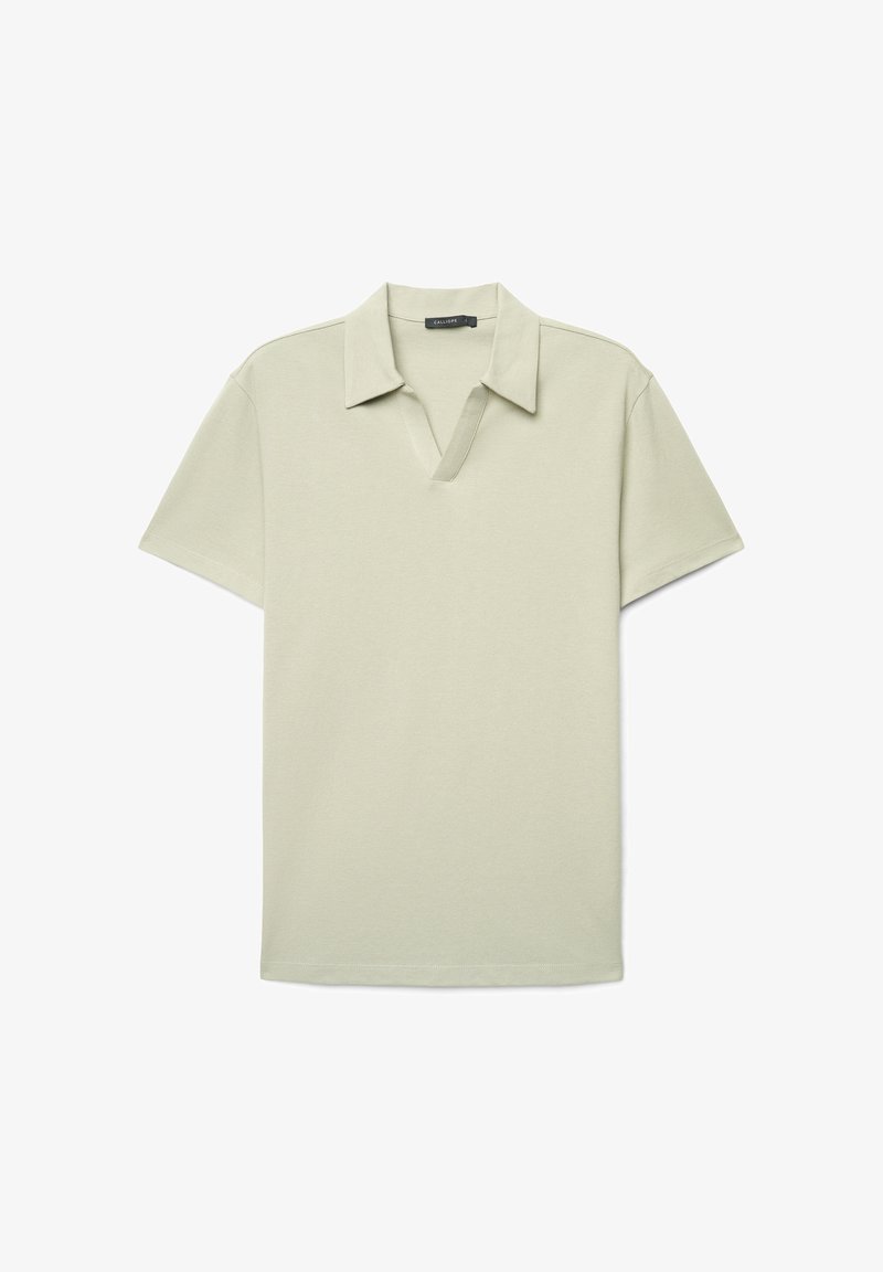 Polo à manches courtes beige clair avec col ouvert et encolure en V, présenté à plat sur un fond blanc.