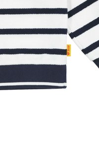Felpa a righe con strisce orizzontali navy e bianche, polsini a coste e una piccola etichetta gialla sul fondo. Texture a maglia morbida.