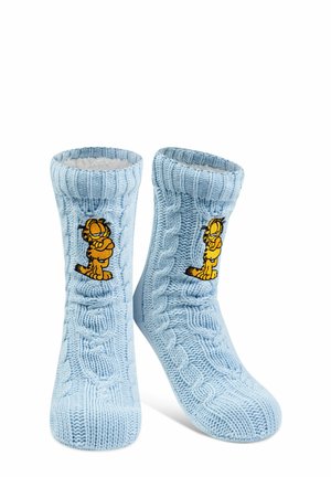 Blue knitted socks with a cable pattern, featuring a yellow cartoon cat embroidered on the front. Soft lining visible at the top.