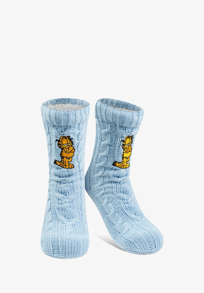 Calze blu lavorate a maglia con un motivo a treccia, featuring un gatto cartoon giallo ricamato sul davanti. Fodera morbida visibile nella parte superiore.