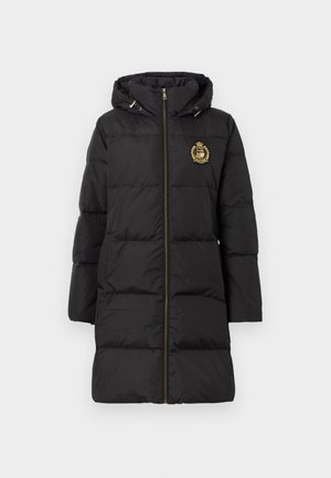 Black puffer coat with a hood, featuring a gold emblem, vertical quilted design, and front zipper closure. Smooth texture and mid-length fit.