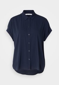 Blouse bleu marine à manches courtes, avec col, tissu doux, ourlet arrondi et coupe décontractée. Présente des fermetures à boutons discrètes.