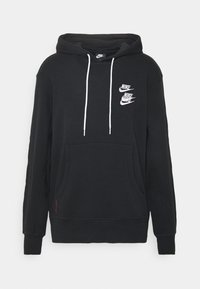 Svart hoodie i bomullsblandning med en känguruficka, vita dragsnören och tre vita Nike-logotyper på bröstet.