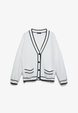 Cardigan bianco con bordi neri, bottoni neri, due tasche frontali e maniche lunghe, mostrato su uno sfondo bianco.