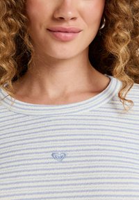 Light blue and white striped sweater with a rounded neckline and soft texture. Features a small embroidered heart detail on the chest.