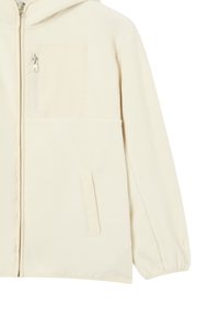 Giacca in pile di colore crema con cappuccio, dotata di tasca sul petto con zip e due tasche frontali, vestibilità ampia e polsini elasticizzati.