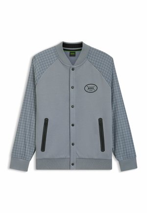 Gray sports jacket with a textured body and checkered patterned sleeves. Features snap buttons and two zippered side pockets.