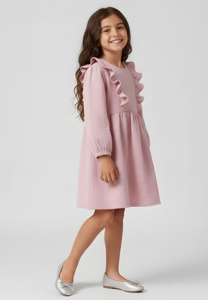 Różowa sukienka z falbanianym dekoltem, teksturowana tkanina, długie rękawy i rozkloszowany dół. Połączona ze srebrnymi płaskimi butami.