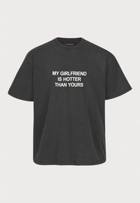 Black cotton t-shirt featuring short sleeves and crew neck, with white text reading “MY GIRLFRIEND IS HOTTER THAN YOURS” printed on the front.