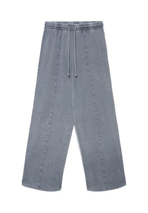 Graue Denimhose mit elastischem Bund und Kordelzug. Verfügt über weite Beine, markante Nähte und eine leicht verwaschene Textur.