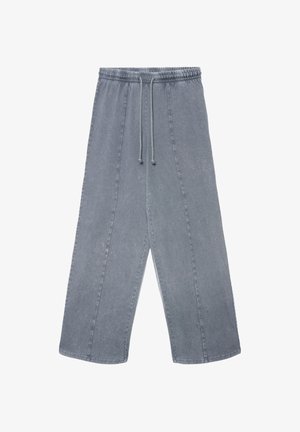 Graue Denimhose mit elastischem Bund und Kordelzug. Verfügt über weite Beine, markante Nähte und eine leicht verwaschene Textur.