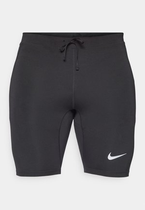 Shorts de sport noirs en tissu extensible, avec une taille élastique à cordon de serrage et un logo Nike blanc sur le bas à gauche.