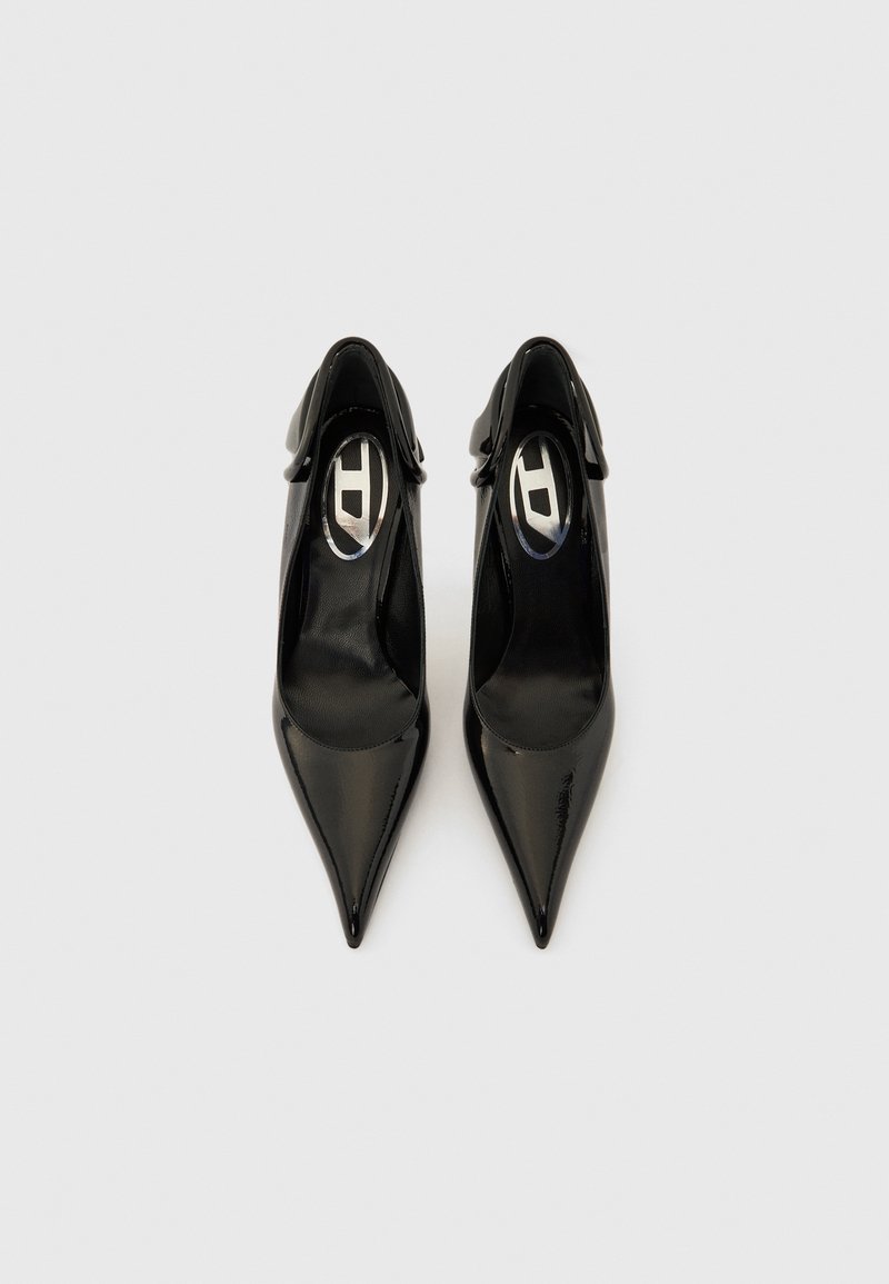 Black patent leather pointed-toe shoes with open backs and ankle straps. Sleek design with a smooth finish and subtle logo detail inside.