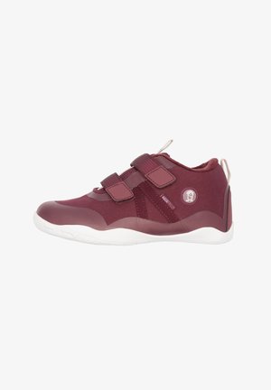 Maroon sneakers with synthetic upper, Velcro straps, textured fabric, and white rubber sole. Features a logo circle on the side.