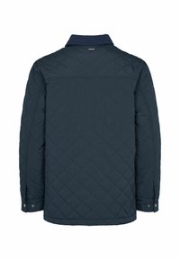 Veste matelassée bleu foncé à manches longues, poignets à boutons-pression et un petit détail rouge, blanc et bleu sur le col arrière.