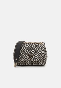 Black and white patterned handbag with a quilted texture, gold chain accent, and a black strap, featuring a triangular logo on the front.