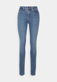 Vaqueros skinny de denim azul con una cintura alta, que cuentan con cinco bolsillos, costuras sutiles y un cierre de botón clásico.