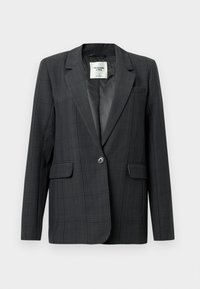 Blazer à carreaux gris foncé avec revers en pointe, fermeture à un bouton et poches avant. Tissu lisse avec une texture subtile. Intérieur doublé.