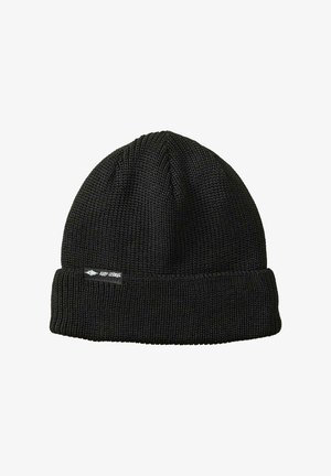 Gorro de punto negro con puño doblado. Presenta una textura de tela acanalada y una pequeña etiqueta en el lateral. Su forma orgánica se adapta a la cabeza.