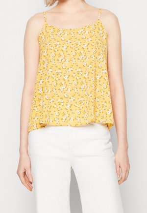 Top senza maniche giallo a fiori con una vestibilità ampia, caratterizzato da piccoli fiori bianchi e viola, spalline a spaghetto e un orlo che curva delicatamente.
