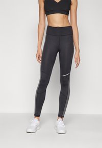 Svarta träningsleggings med hög midja, med grå sidopaneler och "Champion"-logotypen i vitt på underbenet.