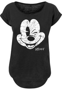 Svart t-skjorte med et slitt hvitt Mickey Mouse-graphic og signatur. Utringning med rullet kort erm, avslappet passform.
