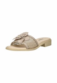 Sandale beige à enfiler avec talon bas, panneau latéral en maille, et grande décoration florale superposée sur la bride.