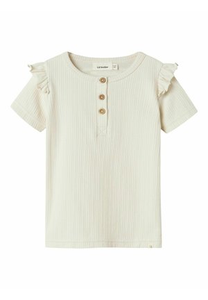 Cream-colored, ribbed short-sleeve shirt with ruffle accents on shoulders and three wooden buttons at the neck.