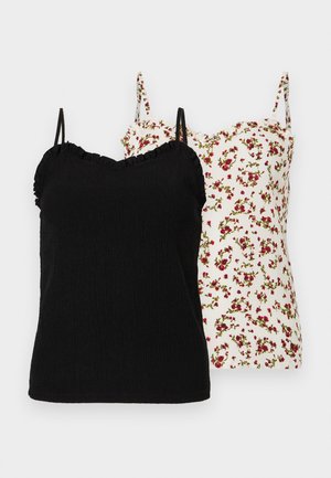 Twee mouwloze dames tops met dunne bandjes, één effen zwart met een gerimpelde halslijn, de andere wit met een rood bloemenpatroon.