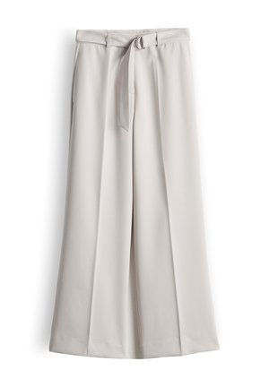 Light beige wide-leg trousers with front pleats and a matching fabric belt with a silver D-ring buckle.
